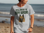 T-shirt with German Shepherd portrait and "Stillness is deeply suspicious" text.