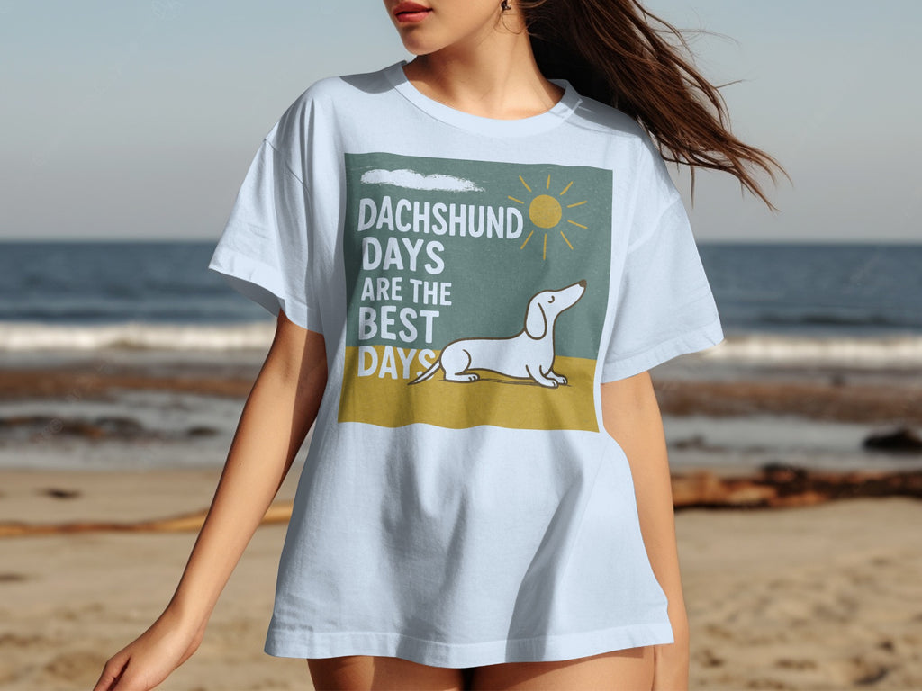 Light blue t-shirt with graphic of dachshund on beach saying "DACHSHUND DAYS ARE THE BEST DAYS".
