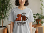Gray t-shirt with graphic of dachshund, coffee, bone, and paw print.