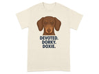 Cream t-shirt with a brown dachshund and text: DEVOTED. DORKY. DOXIE.