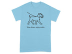 Light blue t-shirt with black line art of a dog on a leash and text "Slow down, enjoy walks".