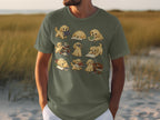 T-shirt with cartoon golden retrievers interacting with books and reading.