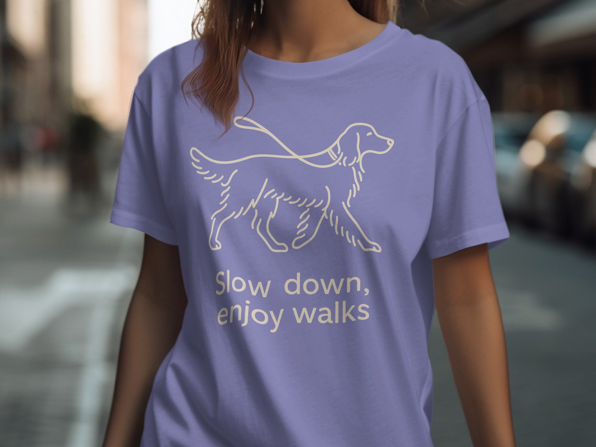 Purple t-shirt with a line drawing of a dog and the text "Slow down, enjoy walks".
