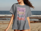 Gray t-shirt with four stacked dachshunds in pastel colors on pink stripes.