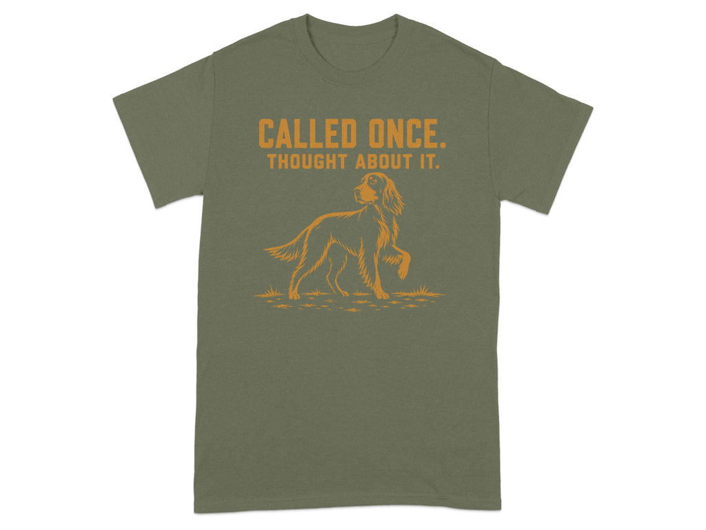 Olive green t-shirt with orange text "CALLED ONCE. THOUGHT ABOUT IT." and dog graphic.