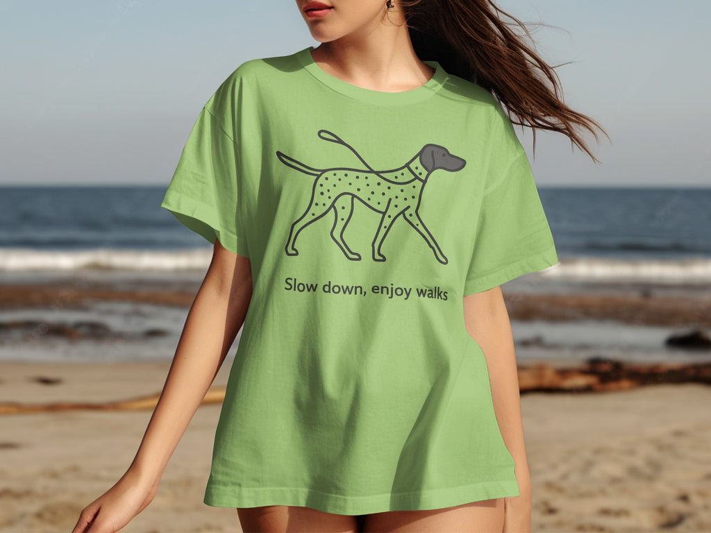 Light green t-shirt with dalmatian graphic and text "Slow down, enjoy walks."