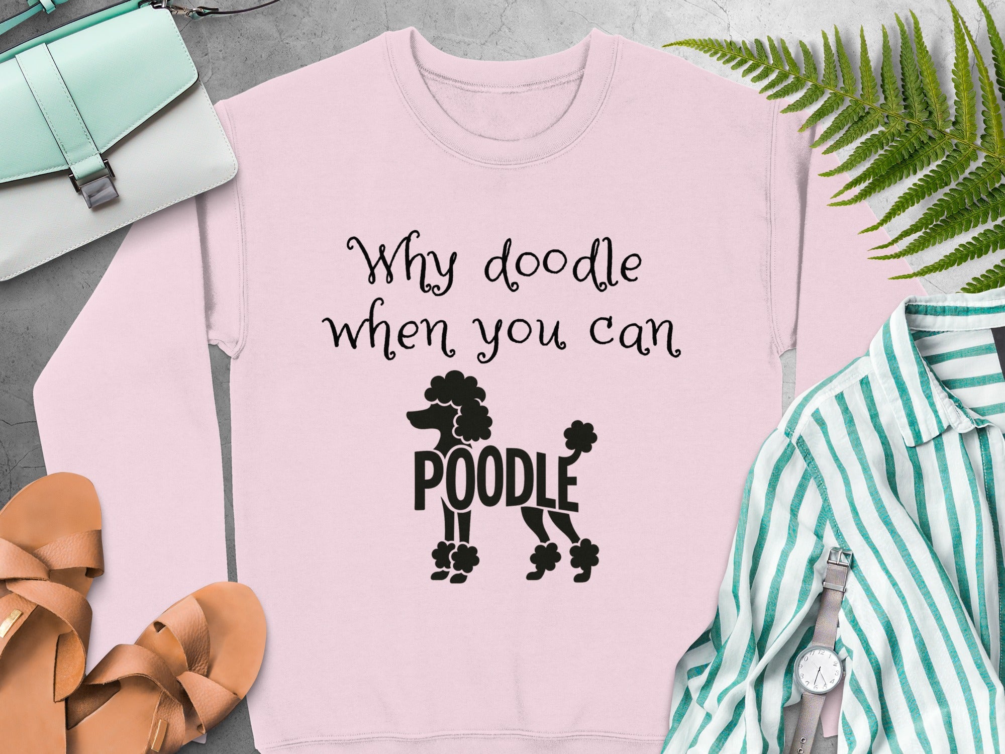 Pink sweatshirt with "Why doodle when you can poodle" text and poodle graphic.