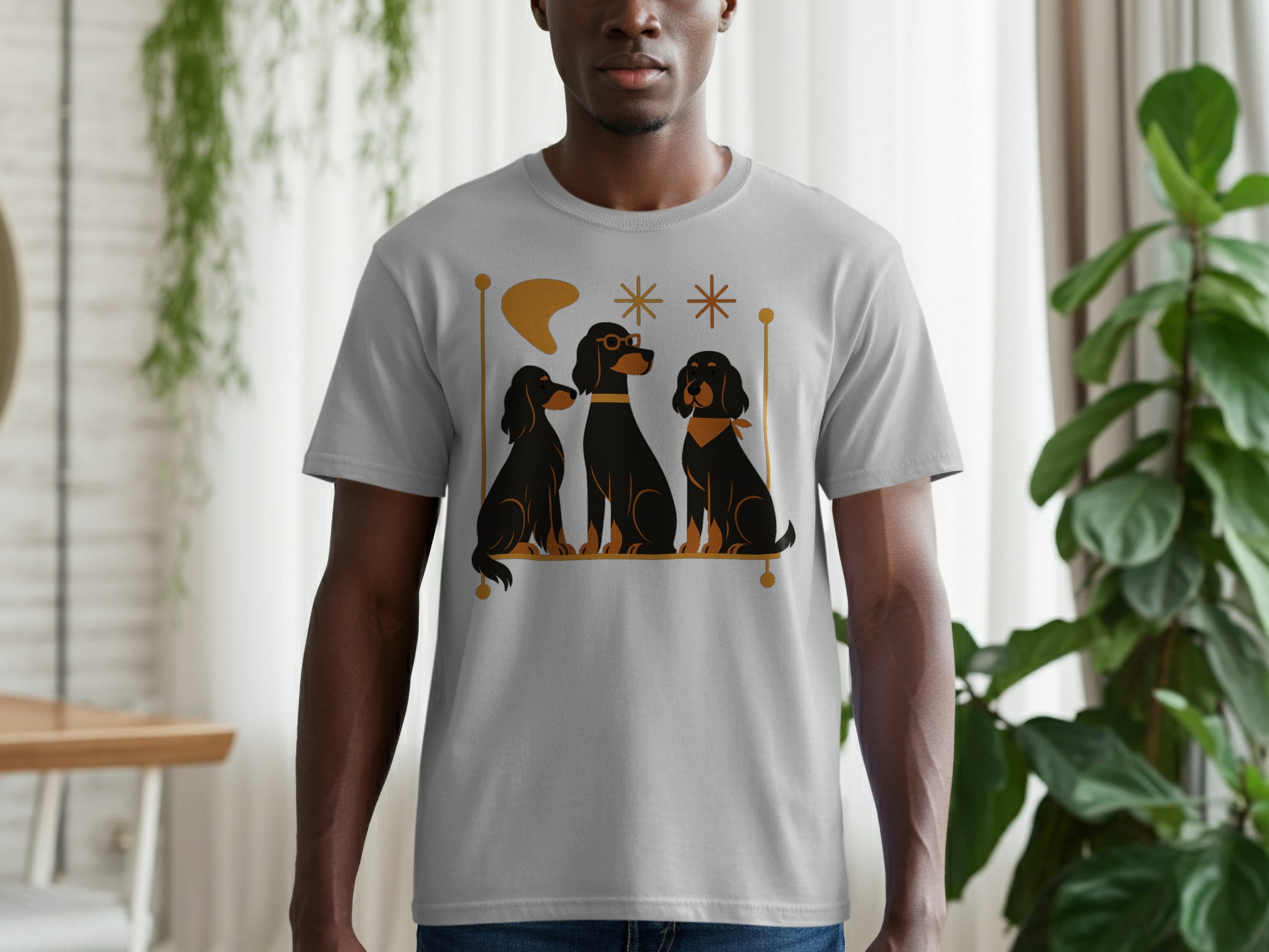 Grey t-shirt with a graphic of three black dogs with gold accents.