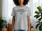 Light grey t-shirt with "LIFE UPDATE: WE ARE BARKING AT THE VACUUM AGAIN" and a dog silhouette.