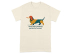 T-shirt with a colorful dachshund illustration and the text "feral little creature, perfectly formed".