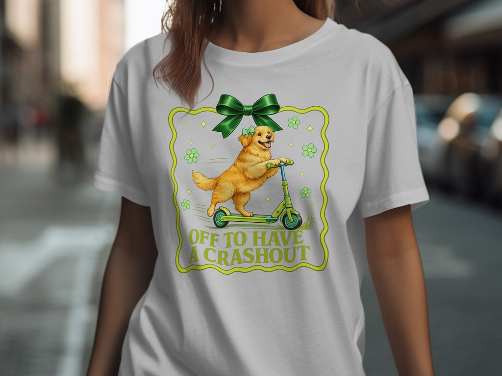 Golden retriever on scooter with text "OFF TO HAVE A CRASH OUT" and green bow.
