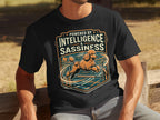 Black t-shirt with orange poodle jumping over obstacle, "Powered By Intelligence & Sassiness" text.
