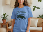 Blue t-shirt with black text "Life update: My lab smelled a thing" and silhouette.