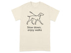 T-shirt with line drawing of a dog on a leash and text "Slow down, enjoy walks."