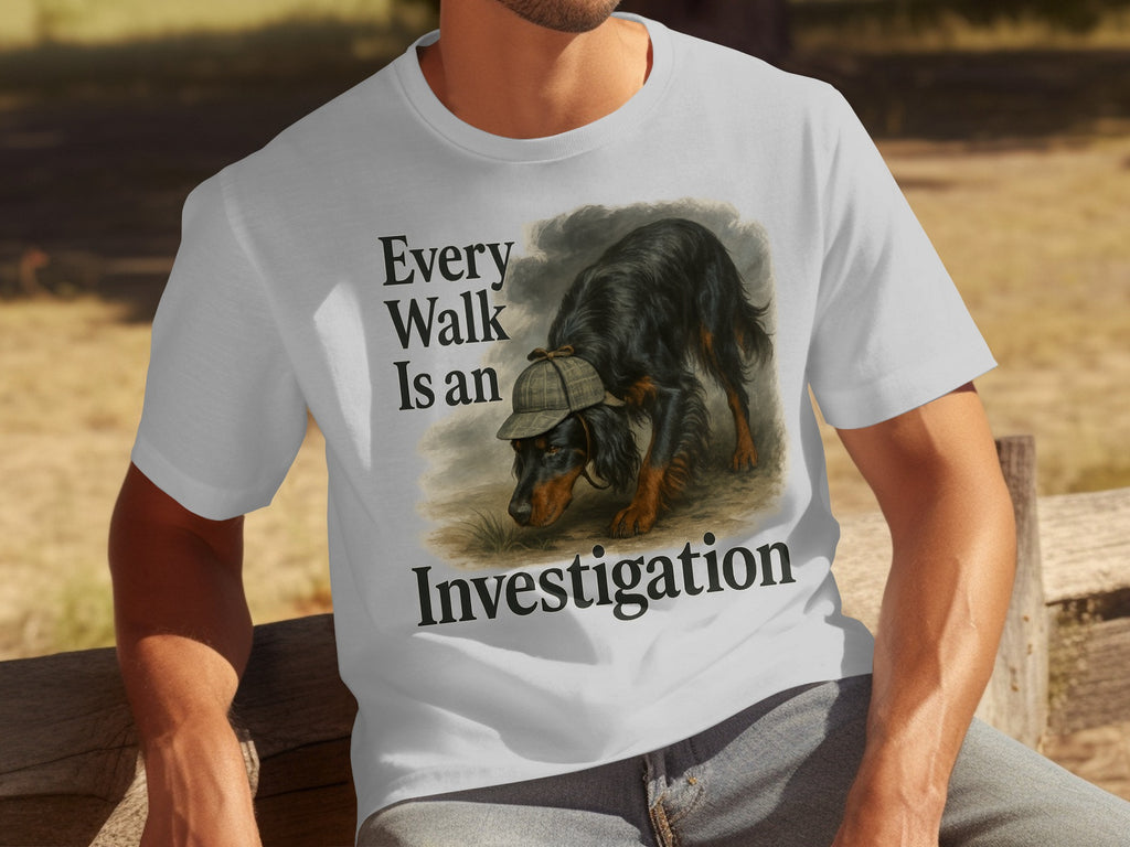 White t-shirt with a black dog wearing a deerstalker hat, text reads "Every Walk Is an Investigation."