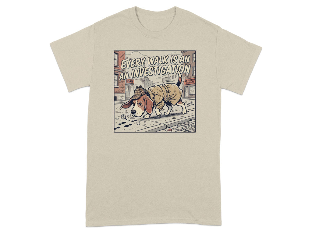 T-shirt graphic of a dog in a trench coat and hat, looking at paw prints.