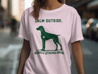 Green dog silhouette with heart on shirt; "CALM OUTSIDE. INTENSELY ATTACHED INSIDE."