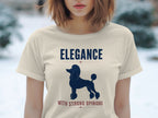 Cream t-shirt with navy poodle silhouette and "ELEGANCE WITH STRONG OPINIONS" text.