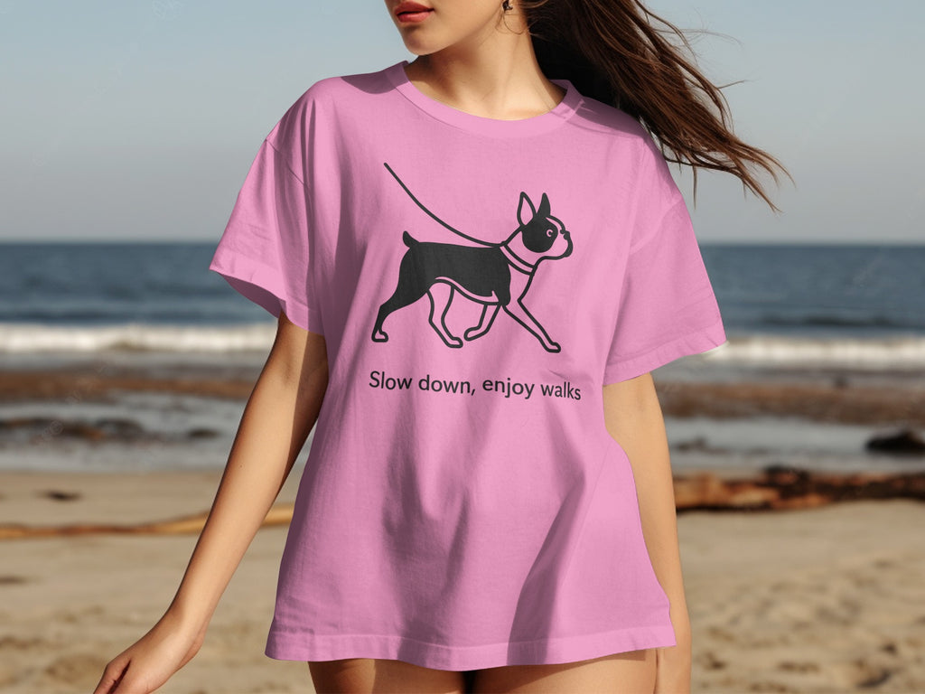 Pink t-shirt with a black dog graphic and text "Slow down, enjoy walks."