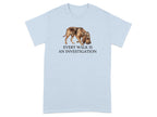 Light blue t-shirt with watercolor dog wearing a hat and the text "EVERY WALK IS AN INVESTIGATION".