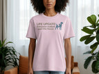 Light pink t-shirt with "LIFE UPDATE Someone walked past the house" and a dog silhouette.