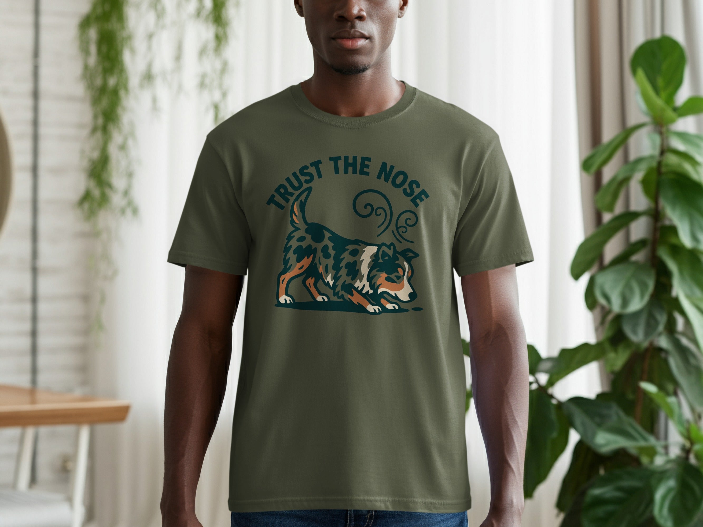Green t-shirt with a graphic of a dog sniffing the ground and the text "TRUST THE NOSE".