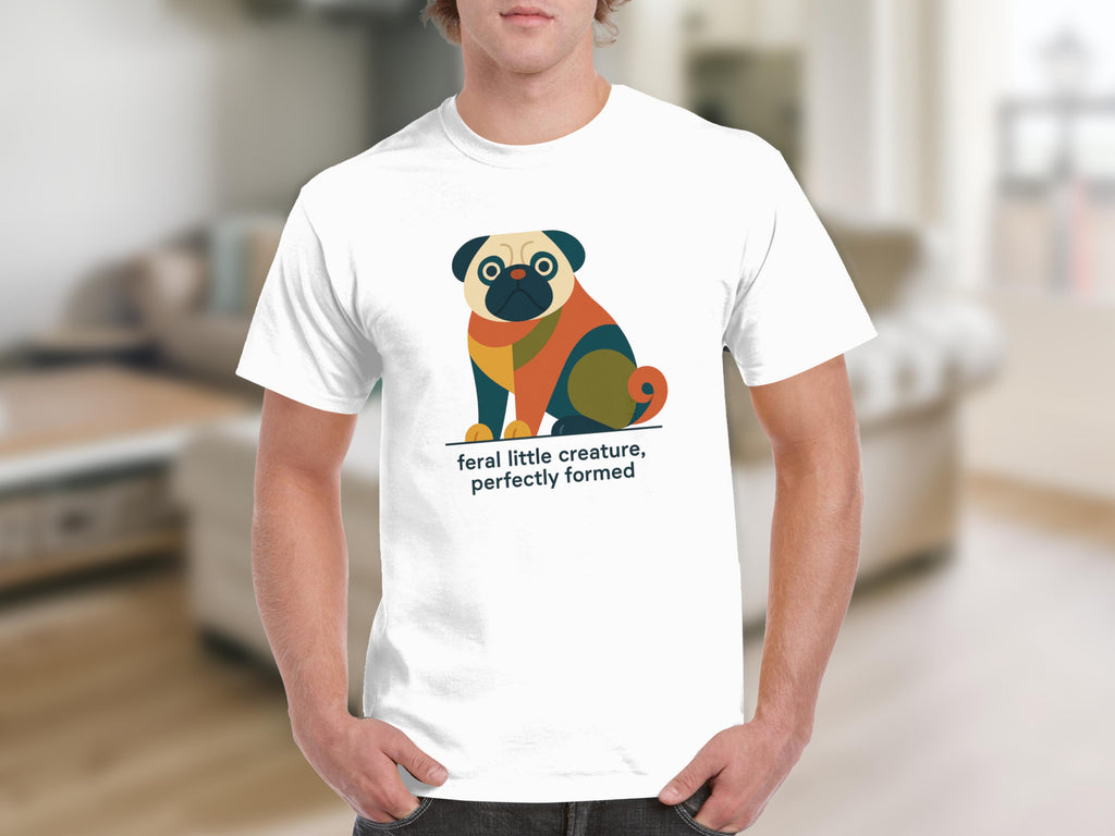 White t-shirt with colorful abstract pug graphic and text: "feral little creature, perfectly formed."