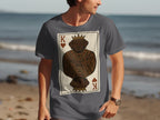 Dark brown dog wearing a crown and patterned tunic on a playing card design.
