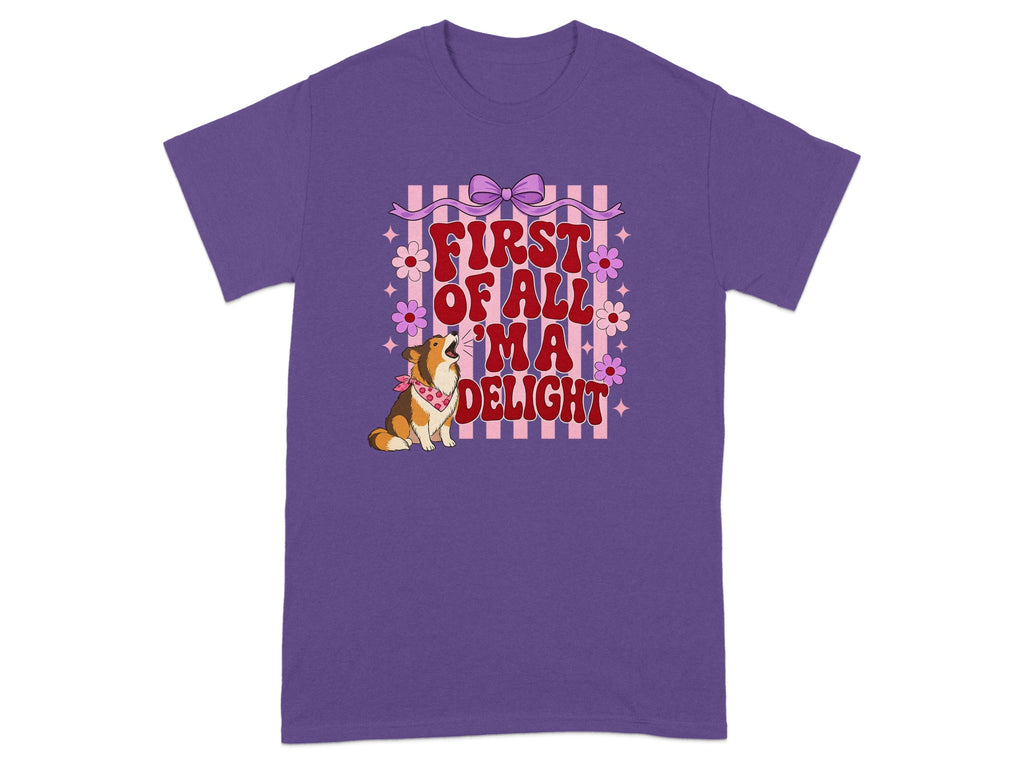 Purple t-shirt with a corgi and text "First of all 'ma delight".