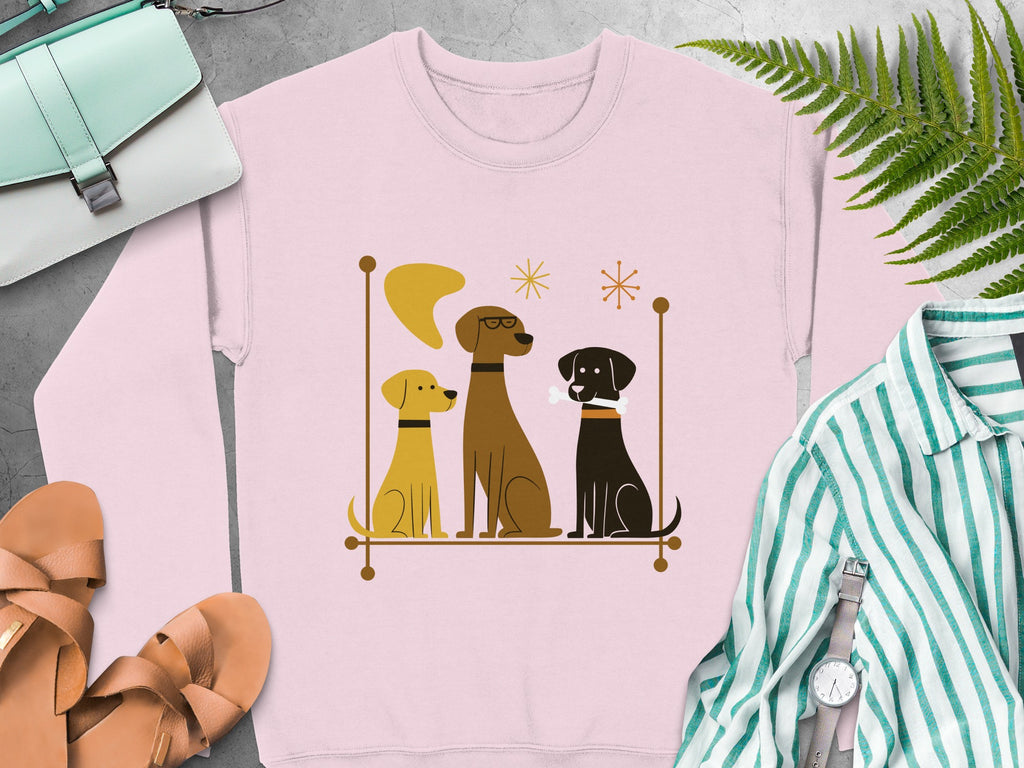 Three dogs, one with a bone, in a retro frame on a pink sweatshirt.