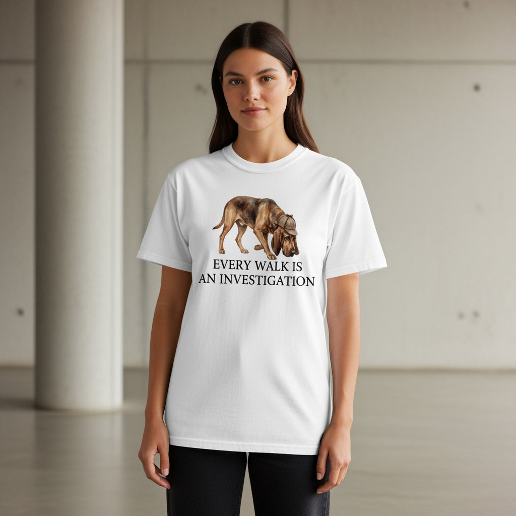 White t-shirt with a dog wearing a detective hat and the text "Every walk is an investigation".