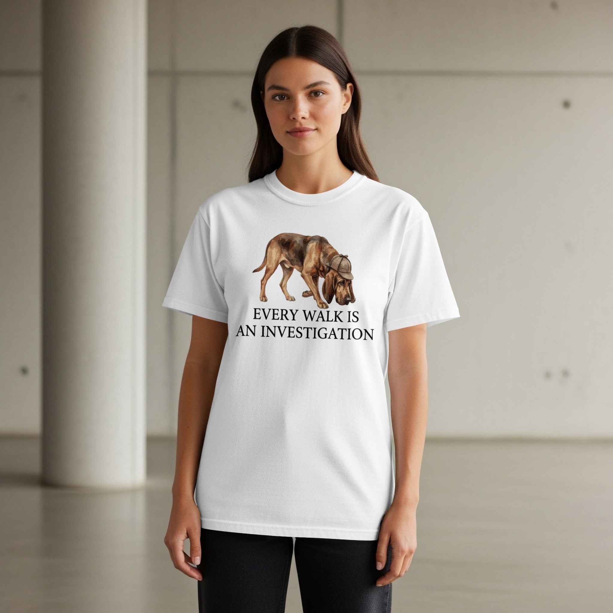 White t-shirt with a dog wearing a detective hat and the text "Every walk is an investigation".