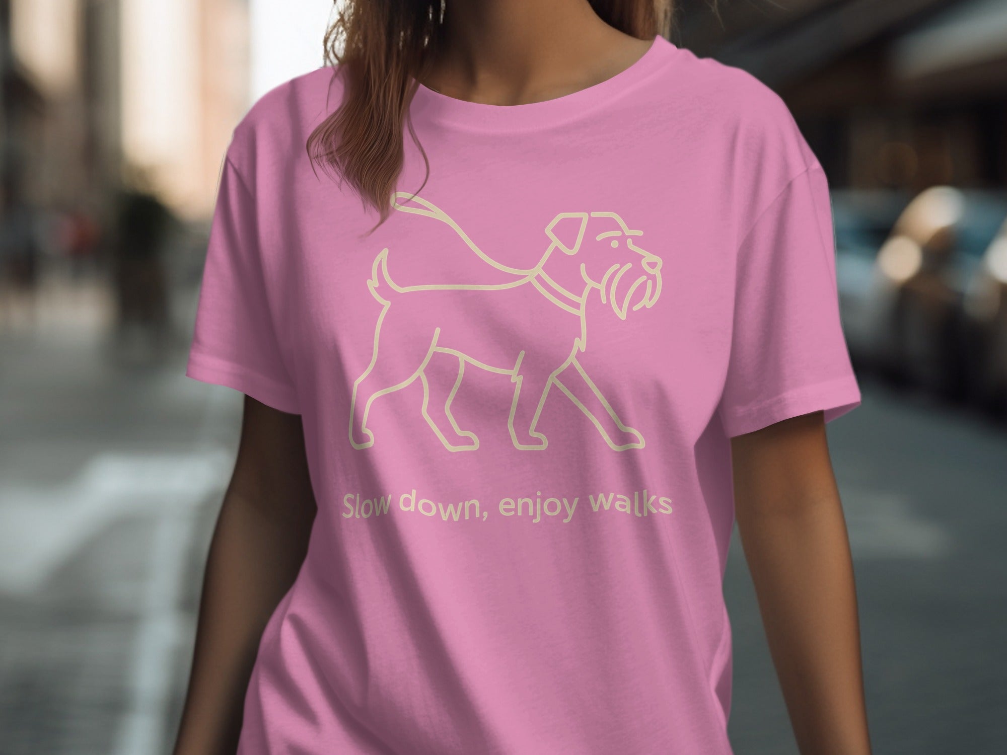 Pink t-shirt with line art of a dog and text "Slow down, enjoy walks."