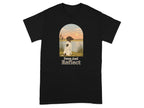 Black t-shirt featuring a German Shorthaired Pointer looking at a sunset over water, with text "Paws And Reflect".