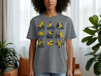 Grey t-shirt with a grid of cartoon yellow dogs riding bicycles and a checkered finish line.