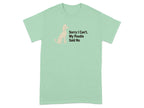 Light green t-shirt with sitting poodle graphic and text.