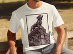 White t-shirt with a black ink illustration of a dachshund on ornate architecture.