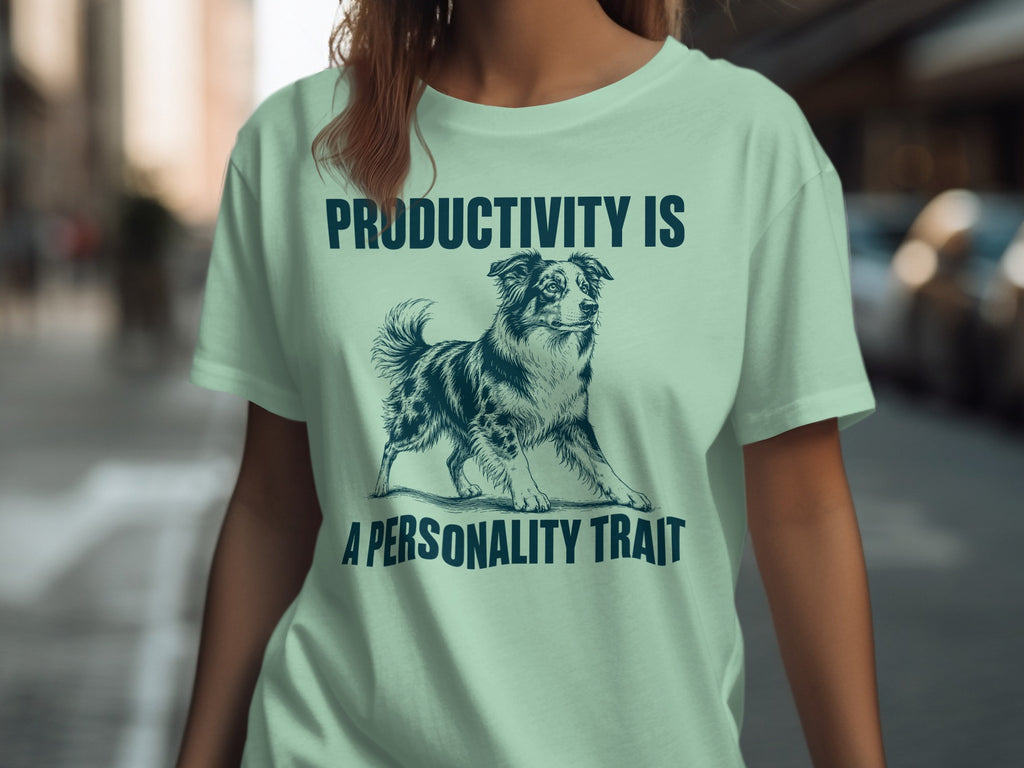 Light mint t-shirt with dog illustration and text "PRODUCTIVITY IS A PERSONALITY TRAIT".