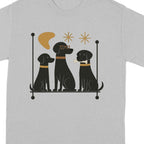 Three black dogs in silhouette with decorative elements on a gray t-shirt.