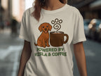 Brown dog sitting by a coffee mug with "Powered by Vizsla & Coffee" text.