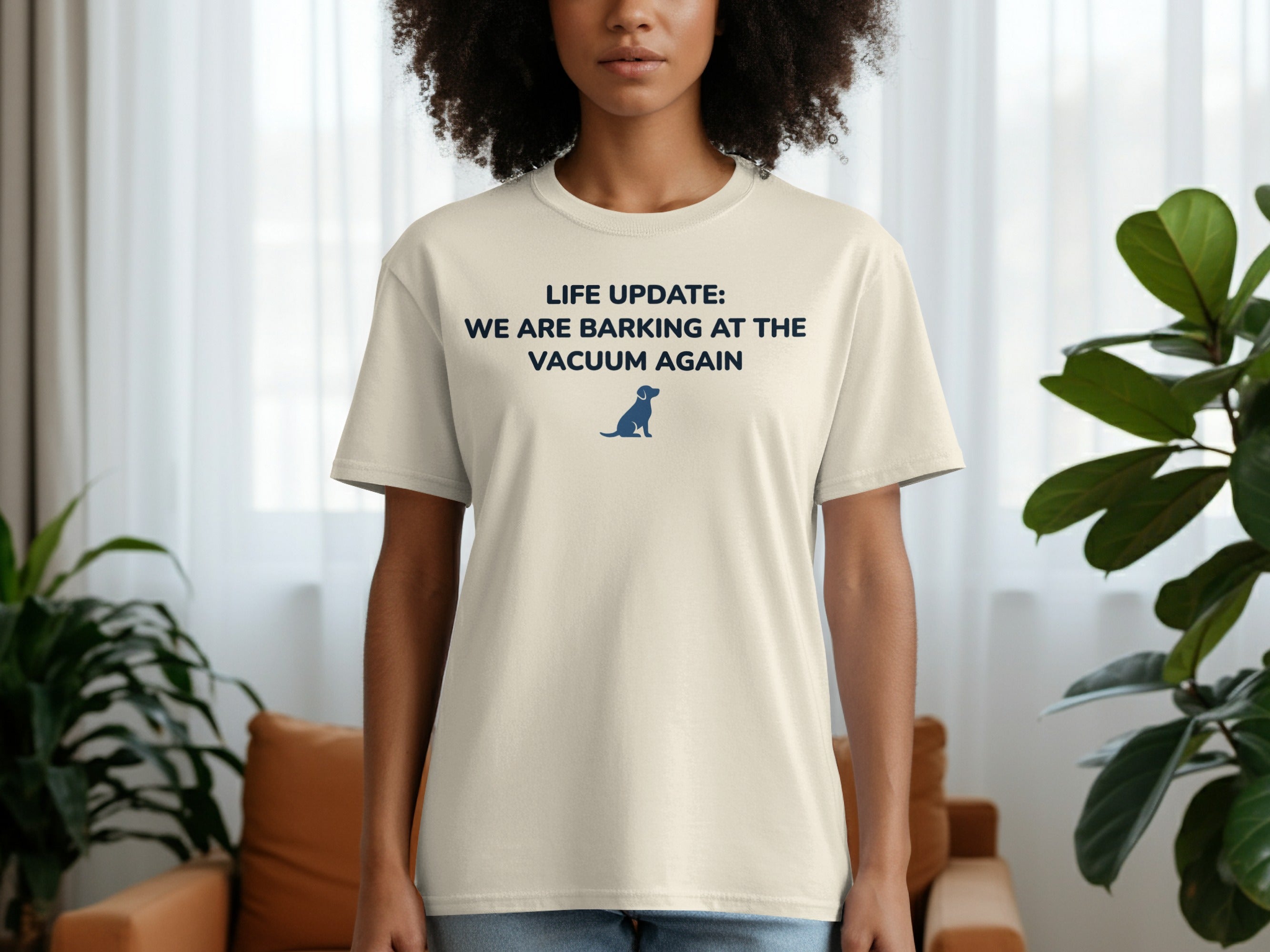 Light tan t-shirt with "LIFE UPDATE: WE ARE BARKING AT THE VACUUM AGAIN" and a dog.