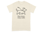 Cream t-shirt with black line drawing of a corgi on a leash and text.