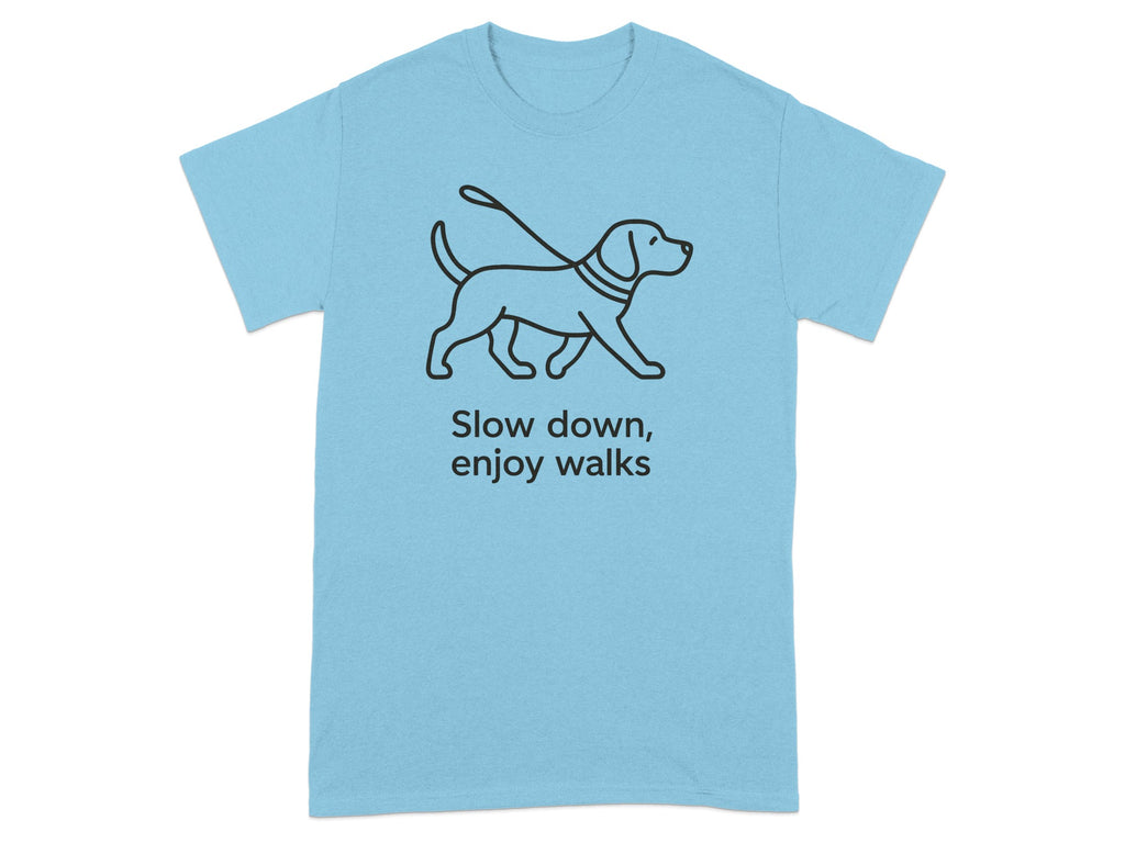 Light blue t-shirt with a black outline of a dog on a leash and text "Slow down, enjoy walks".