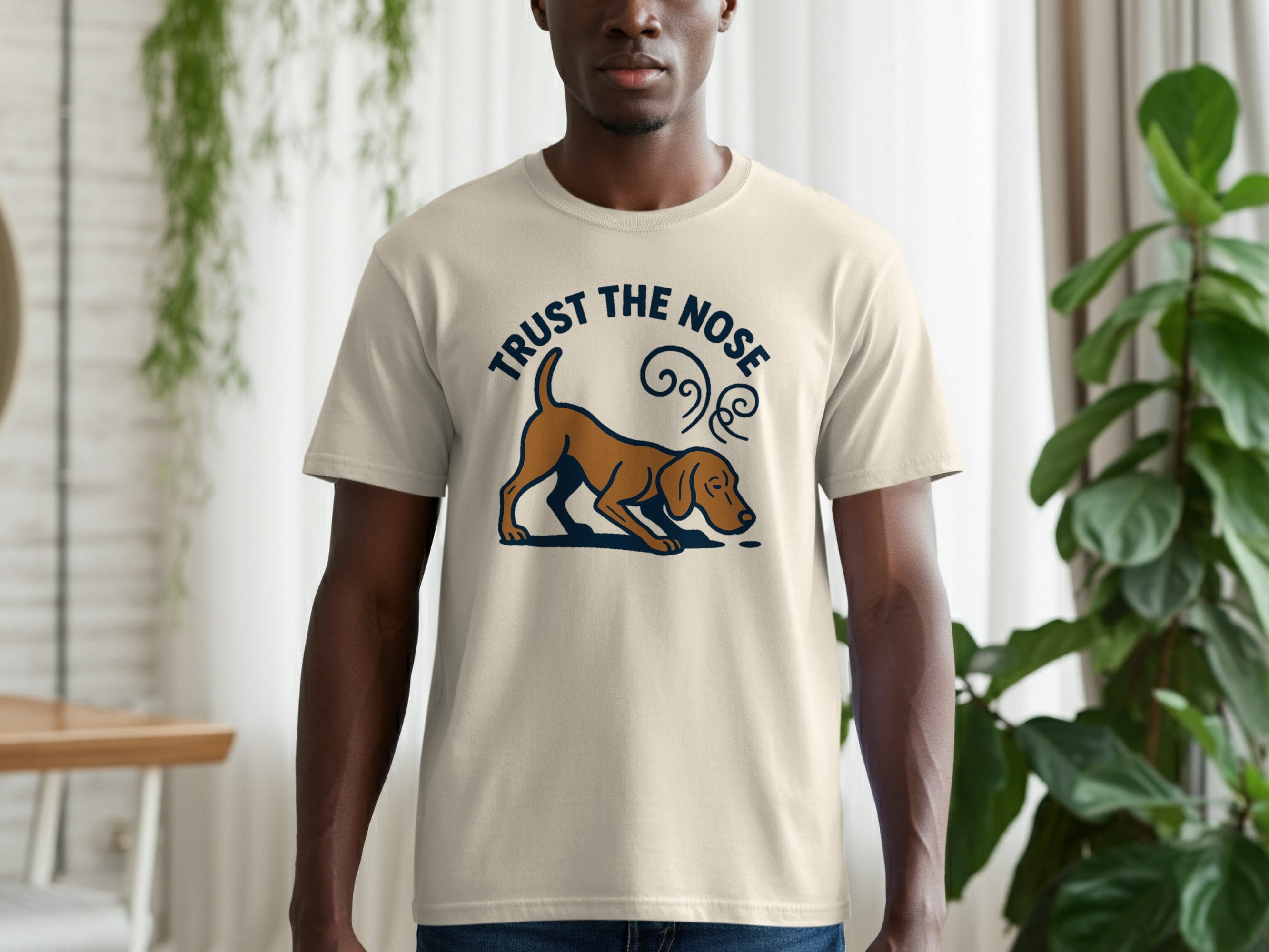 Light-colored t-shirt with brown dog graphic and "Trust the Nose" text.