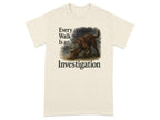 Cream t-shirt with a chocolate lab wearing a detective hat and the text "Every Walk Is an Investigation".