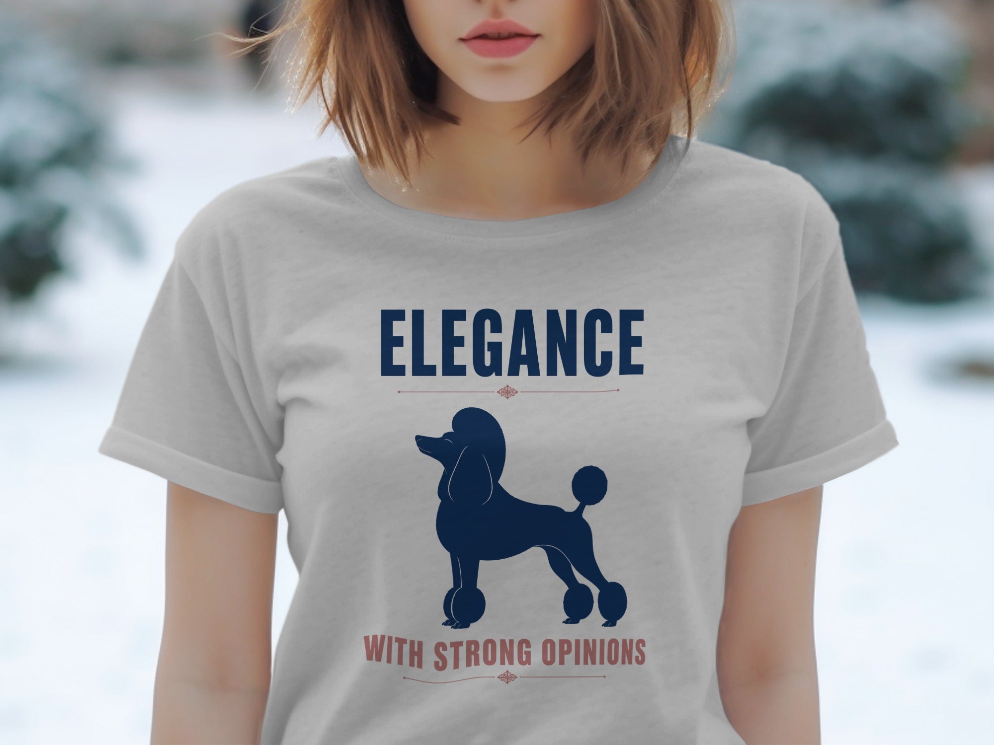 Light gray t-shirt with navy poodle silhouette and "ELEGANCE WITH STRONG OPINIONS" text.