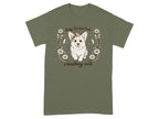 Green t-shirt with a corgi wearing a bow, surrounded by flowers and feathers. Text reads "Sorry I'm late I was crashing out".