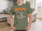 Green t-shirt with a dog running in water, text reads "Driven by Motion and Anxiety".
