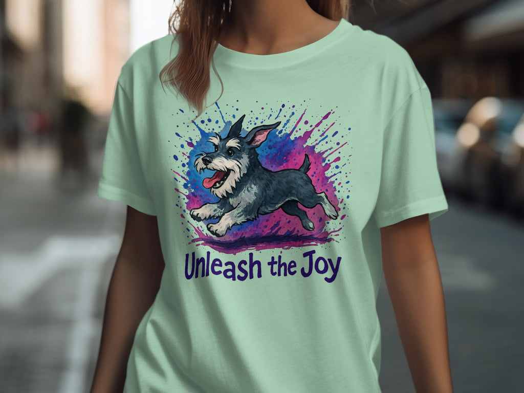 Light green t-shirt with a running schnauzer graphic and the text "Unleash the Joy."