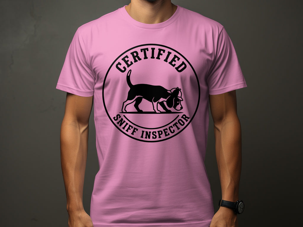 Pink t-shirt with a circular black graphic of a dog wearing a hat and the text "Certified Sniff Inspector".
